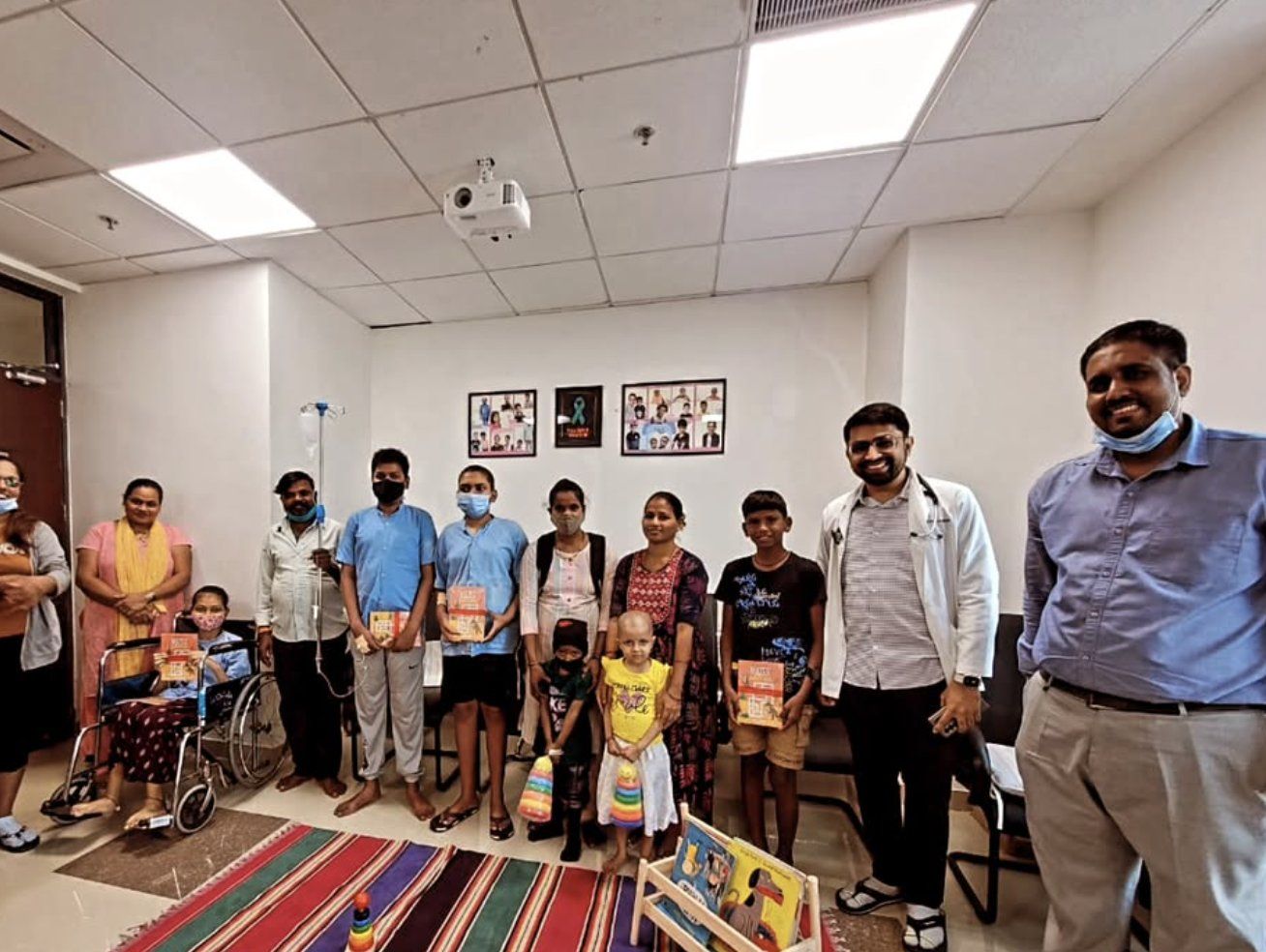 Children, parents, a doctor and Sabrcare volunteers in the play corner on the oncology ward